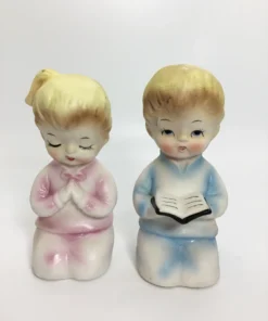 Vintage ceramic salt and pepper shakers with praying children in pastel clothing