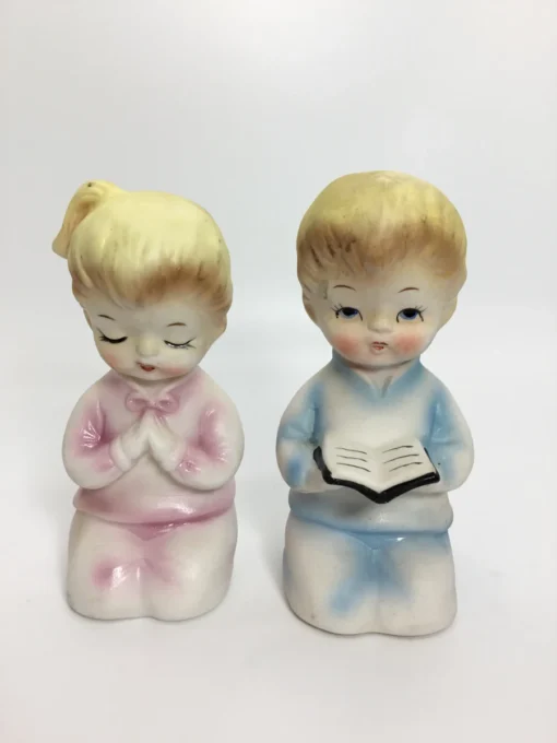 Vintage ceramic salt and pepper shakers with praying children in pastel clothing