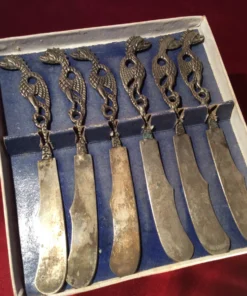 Open box view – set of six antique butter knives with ornate dragon handles