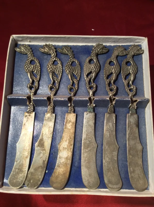 Dragon handle detail – close-up of sculpted knife handles in box