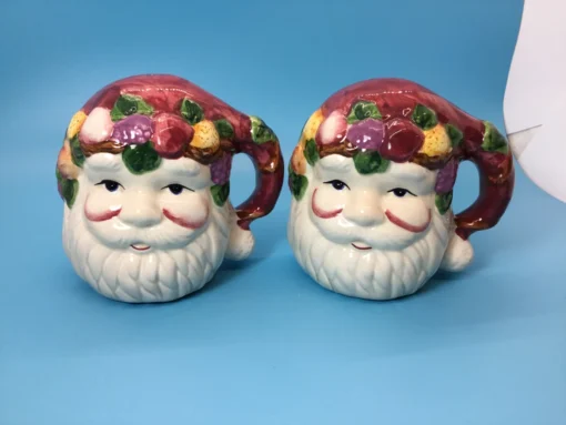 Pair of vintage Santa Claus salt and pepper shakers with fruit-laden hats