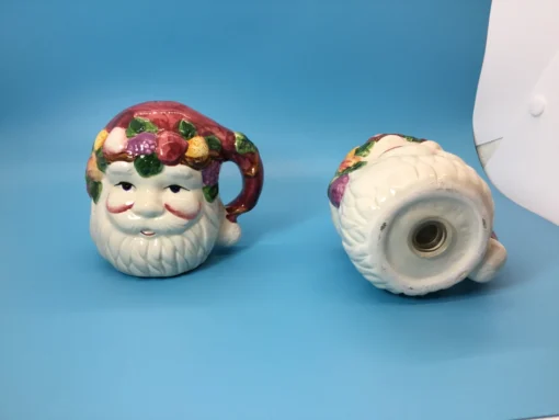 Vintage ceramic Santa salt shaker showing bottom opening