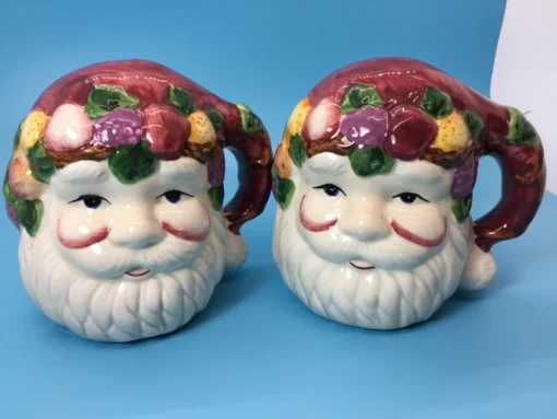 Front close-up of hand-painted Santa Claus face shakers with holiday fruit details