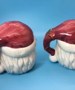Back view of Santa shakers with maroon hats shaped like handles
