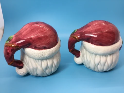 Back view of Santa shakers with maroon hats shaped like handles