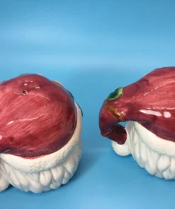 Back view of Santa shakers with maroon hats shaped like handles 1