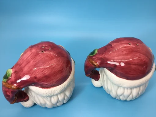 Back view of Santa shakers with maroon hats shaped like handles 1
