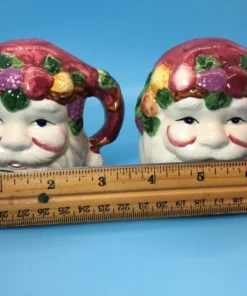 sized Front close-up of hand-painted Santa Claus face shakers with holiday fruit details