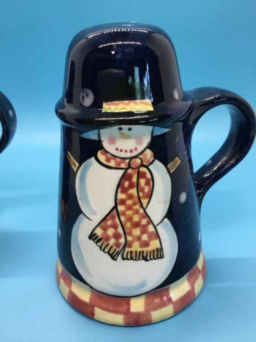 A festive duo of vintage snowmen salt and pepper shakers, ready to add cheer to your holiday table or winter decor display. 4