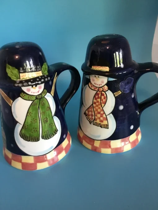 A festive duo of vintage snowmen salt and pepper shakers, ready to add cheer to your holiday table or winter decor display. 8