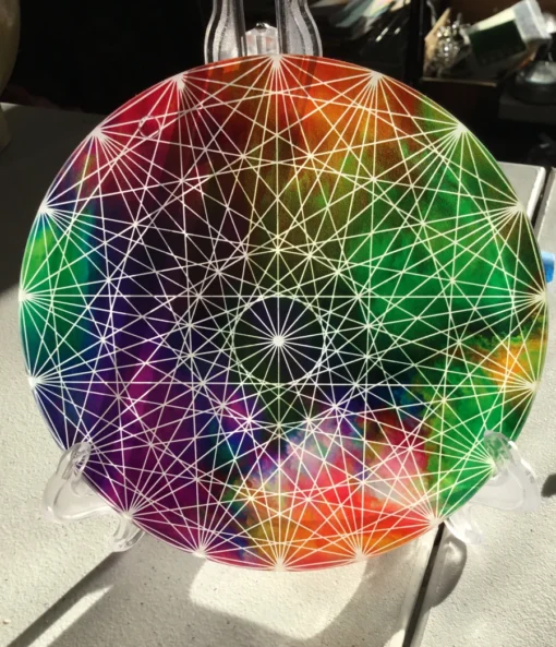 Close-up of symmetrical sacred geometry over vibrant color field