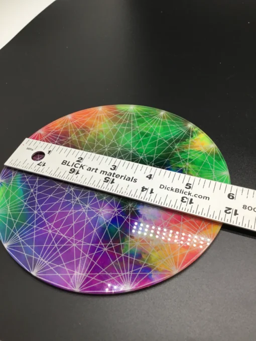 Rainbow geometric plate measured with ruler for scale (approx. 6"