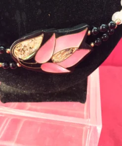 Close-up of pink lotus pendant with abalone shell inlay