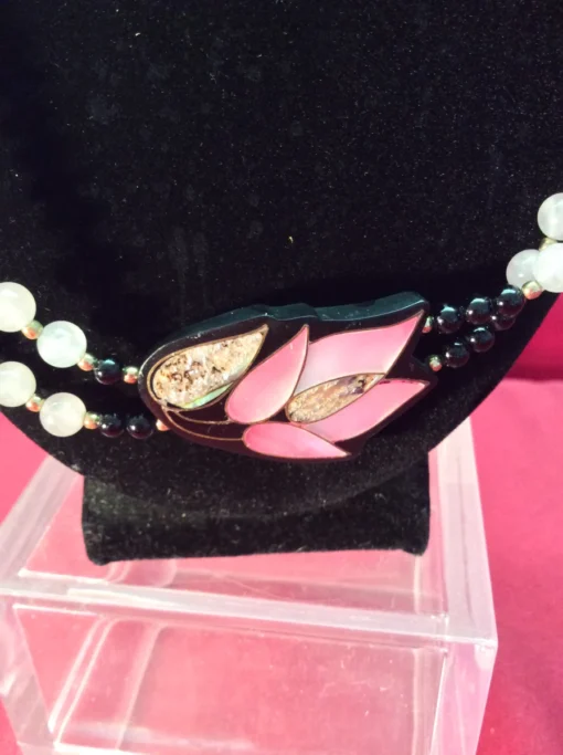 Angled shot of lotus inlay with bead strands