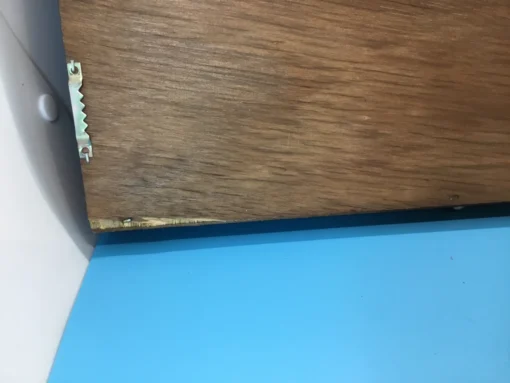 Close-up of sawtooth hanger on the back of the rubber stamp case