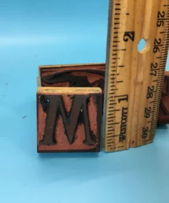 Rubber stamp measured against a ruler to show height in inches