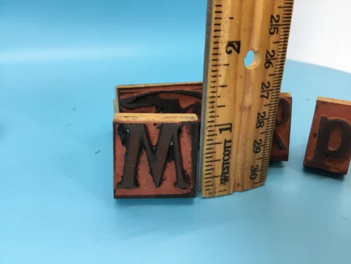 Rubber stamp measured against a ruler to show height in inches