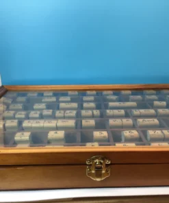 Front-facing view of entire wooden stamp case with ruler across bottom