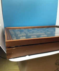 Side of vintage stamp case showing minor wear and aged wood