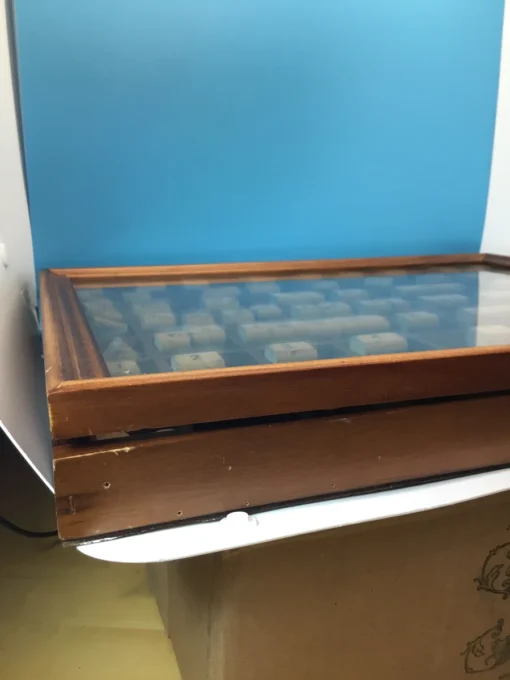 Side of vintage stamp case showing minor wear and aged wood