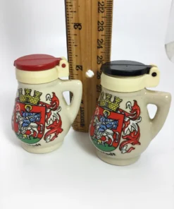 German stein salt and pepper shakers next to a ruler for scale