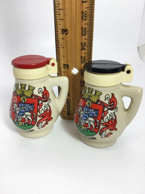 German stein salt and pepper shakers next to a ruler for scale