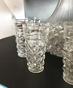 Close-up of matching glasses from vintage crystal-style decanter set